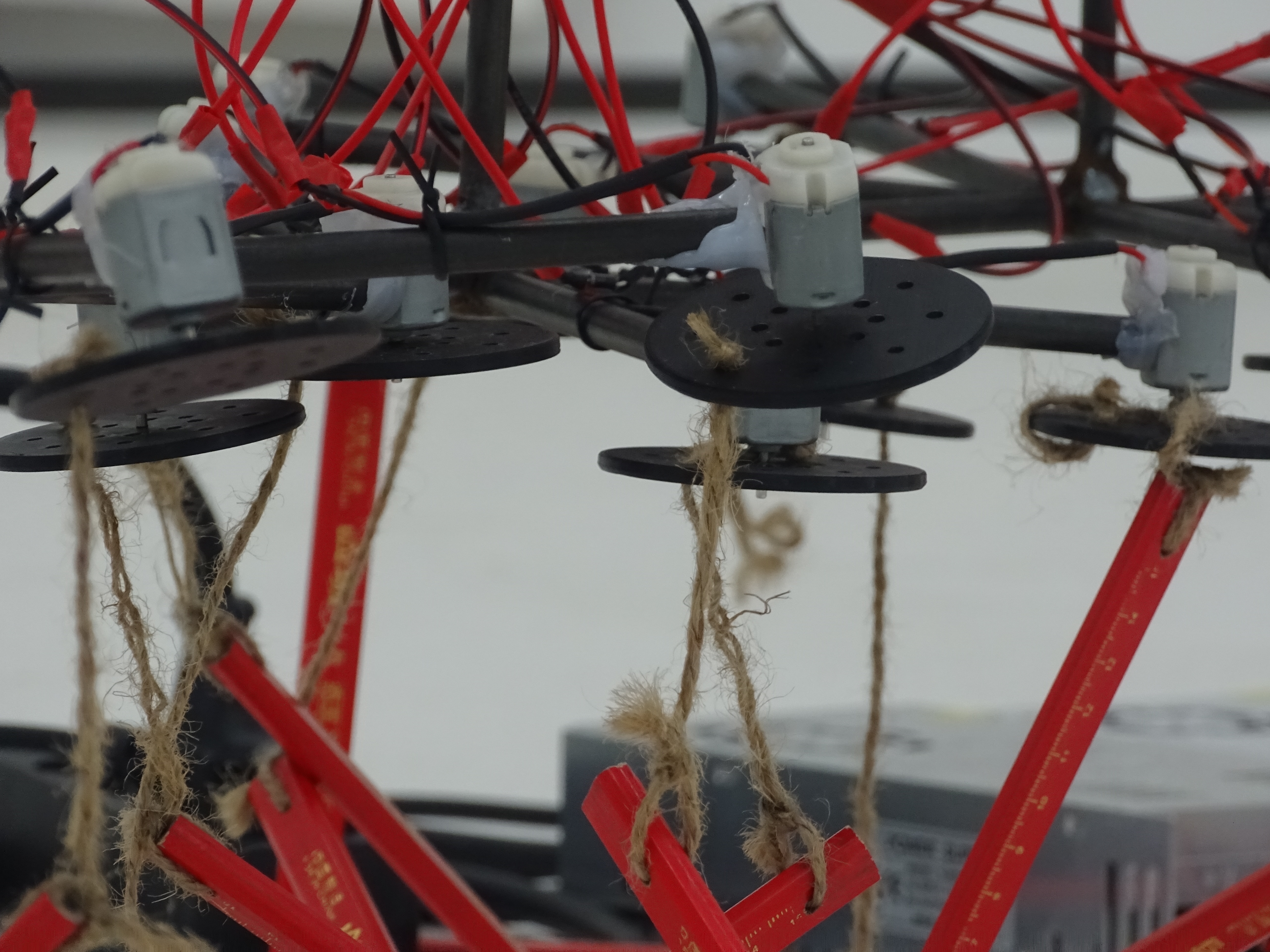 Pencils spinning: six identical motors, identical pencils, identical mounting. Variation is a feature.